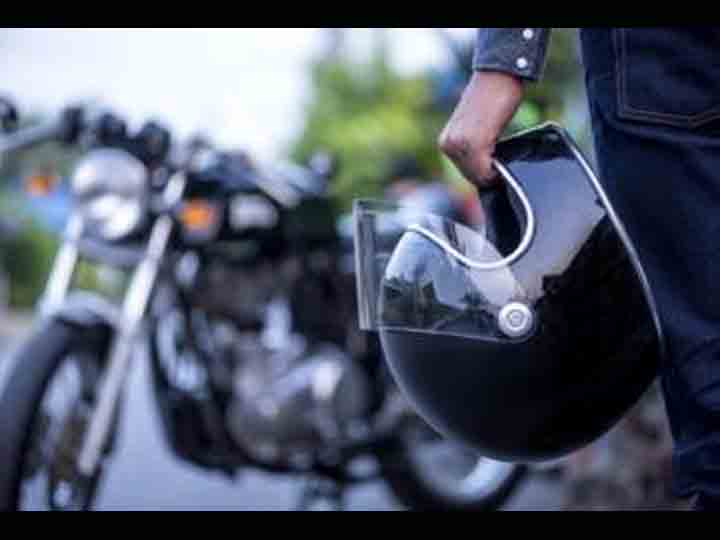 motorcycle driver holding a helmet (1)