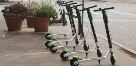 Electric Scooters standing up in a group
