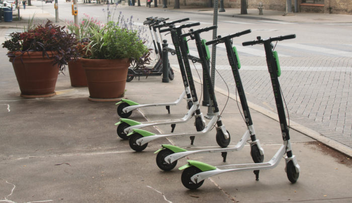 Electric Scooters standing up in a group