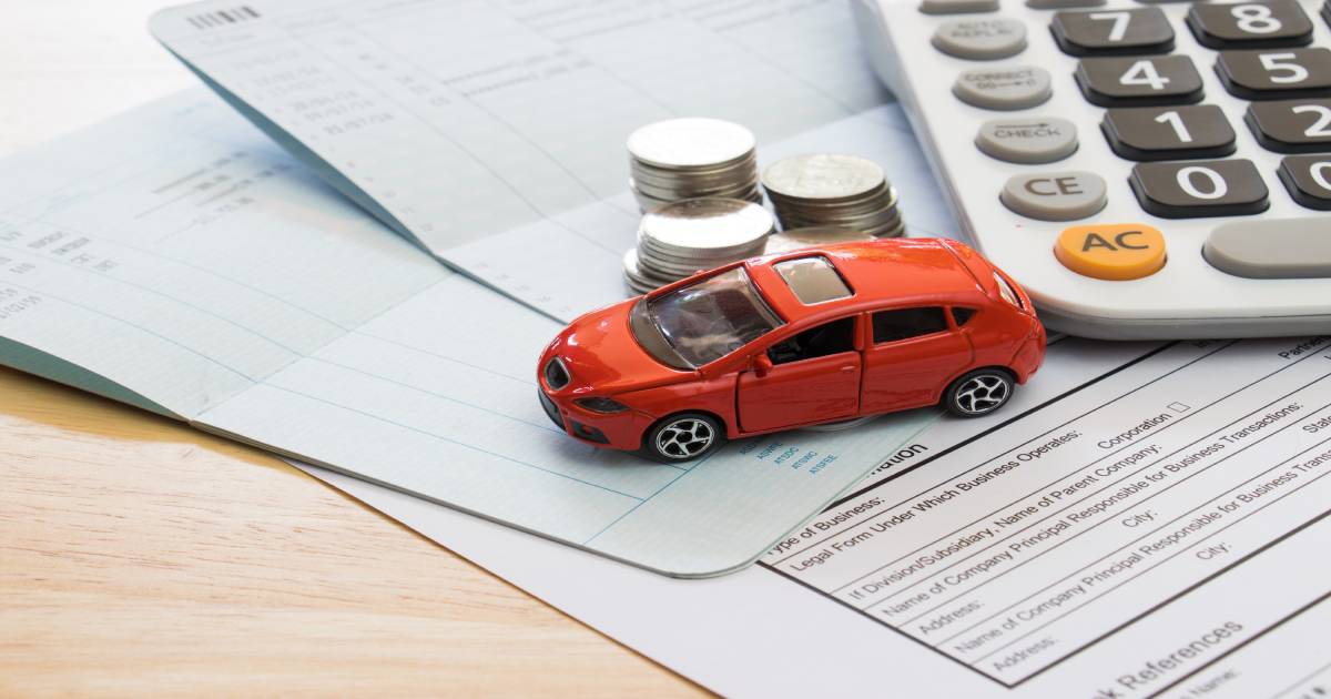 toy car and money on a paper representing car insurance