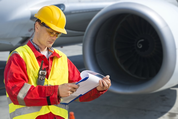 airplane engineer reviewing checklist