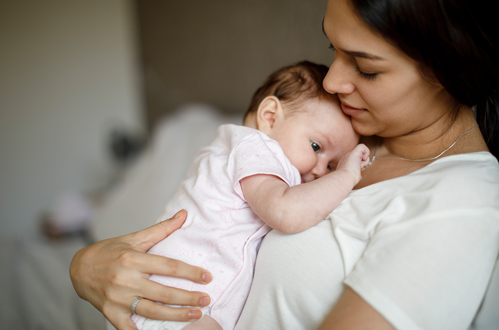 a woman holding her baby