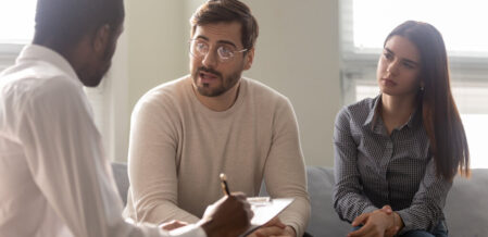 doctor giving medical advice about workers comp to a couple