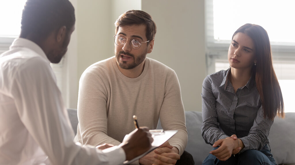 doctor giving medical advice about workers comp to a couple