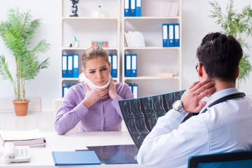 person with neck injury talking to a doctor