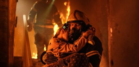 firefighter carrying young girl from burning building in South Carolina