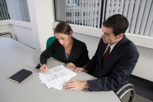 people signing papers