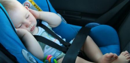 baby sleeping on a car seat