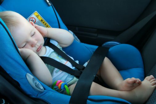 baby sleeping on a car seat