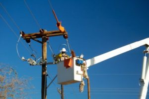 Electric utility lineman working on power lines.