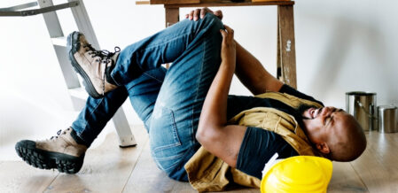 a construction worker with an injured knee after he fell off a ladder
