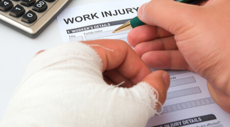 worker filling out work injury claim form