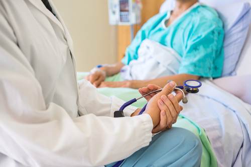 image of patient sitting with medical employee