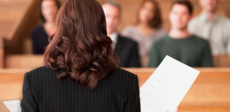 a woman standing in front of a jury