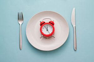 red alarm clock on a white plate