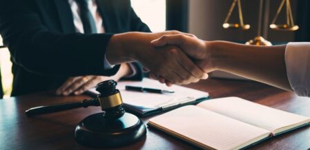 a lawyer shaking hands with their client