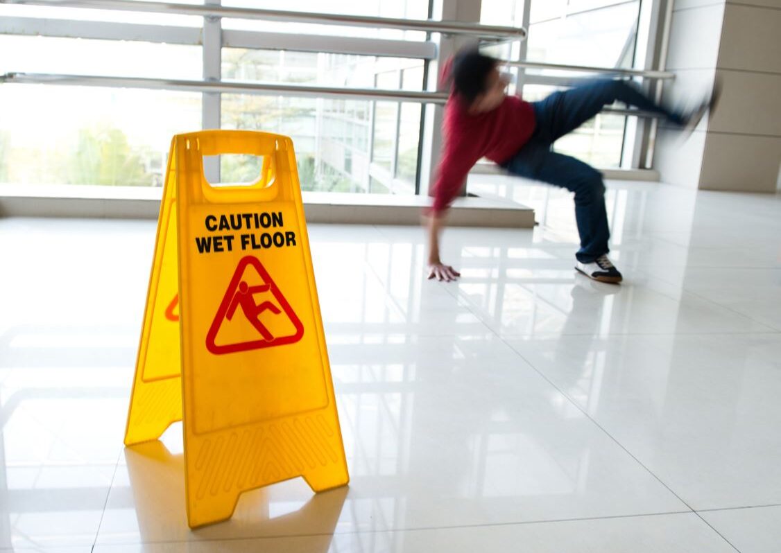 slip and fall accident with a warning sign on