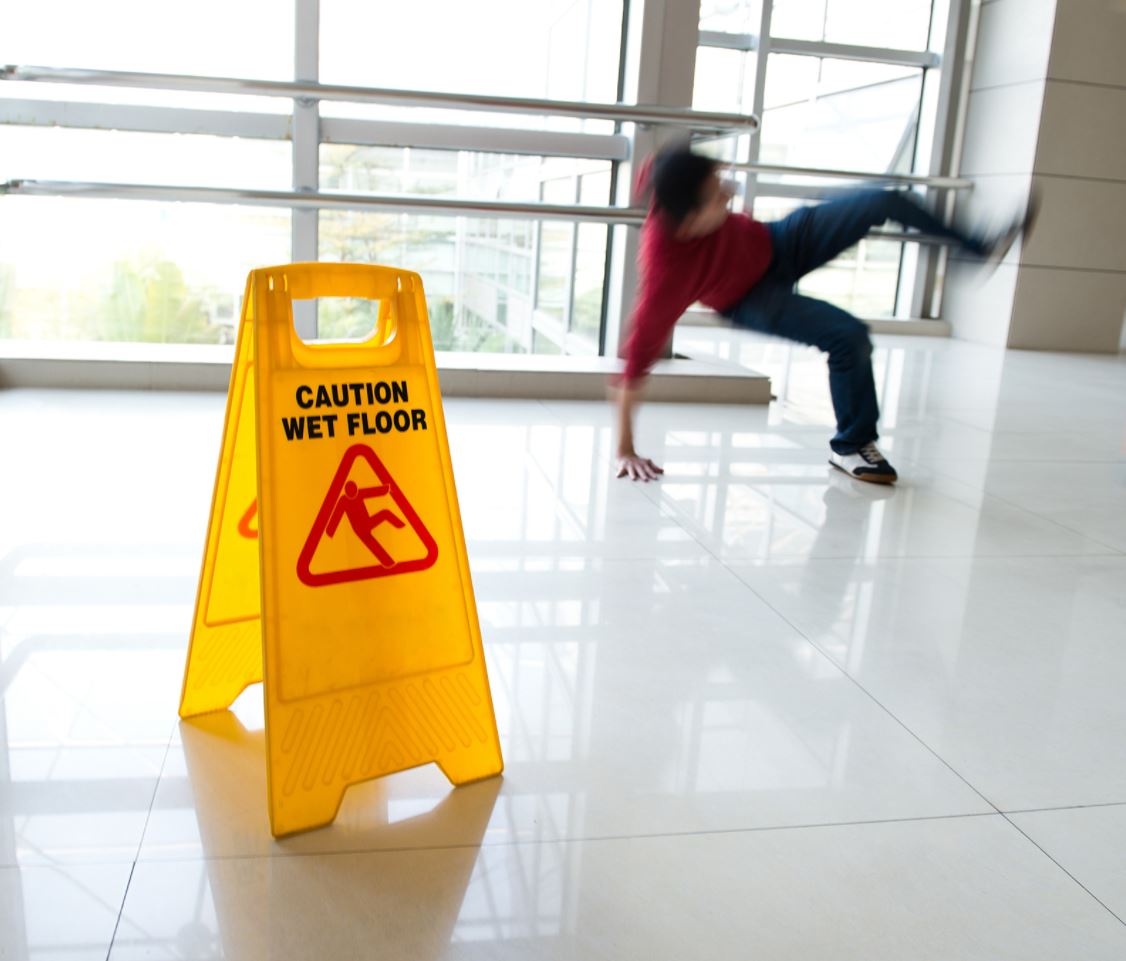 slip and fall accident with a warning sign on