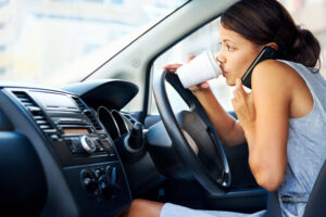  Businesswoman-multitasking-while-driving-drinking-coffee-and-talking-on-the phone