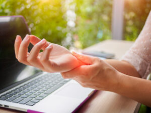 a woman enduring a carpal tunnel pain