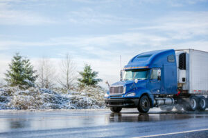 blue truck in a snowy road