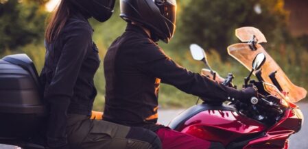 two people riding on a motorcycle together