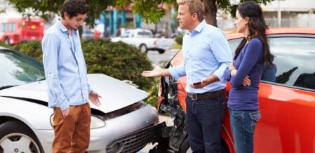 a man angry with a teen after they have been in a car accident