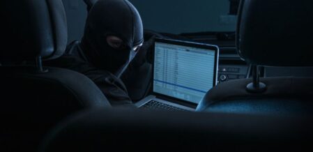 thief hacking car computer