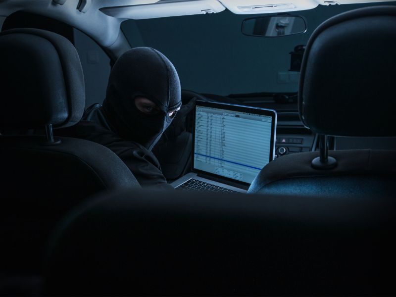 thief hacking car computer