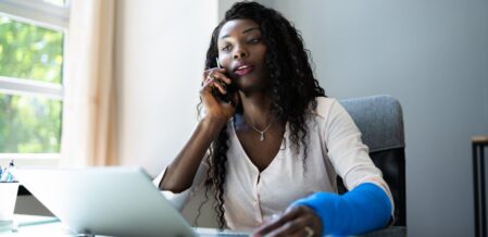 Image of a woman in a cast talking on the phone