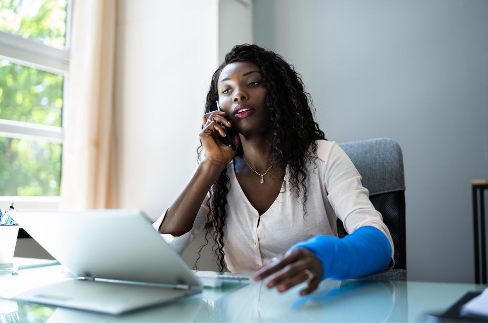 Image of a woman in a cast talking on the phone