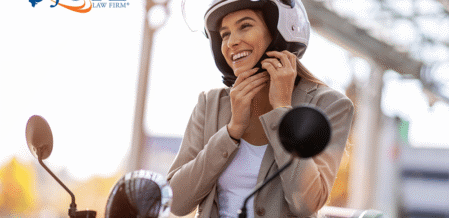Image of a woman on a moped strapping on a helmet