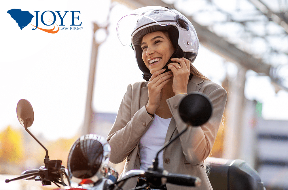 Image of a woman on a moped strapping on a helmet