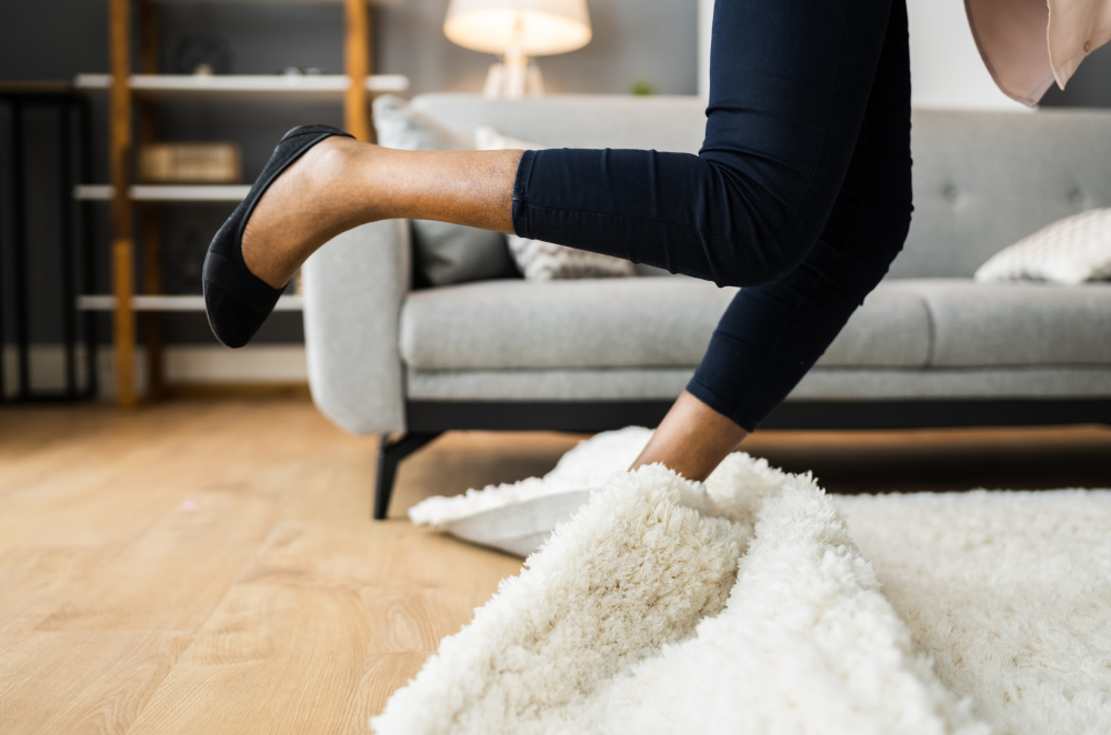 Image of a woman tripping on a rug in a living room