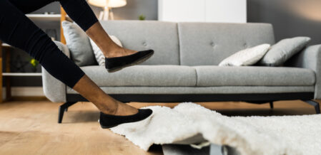 Image of someone tripping on a rug