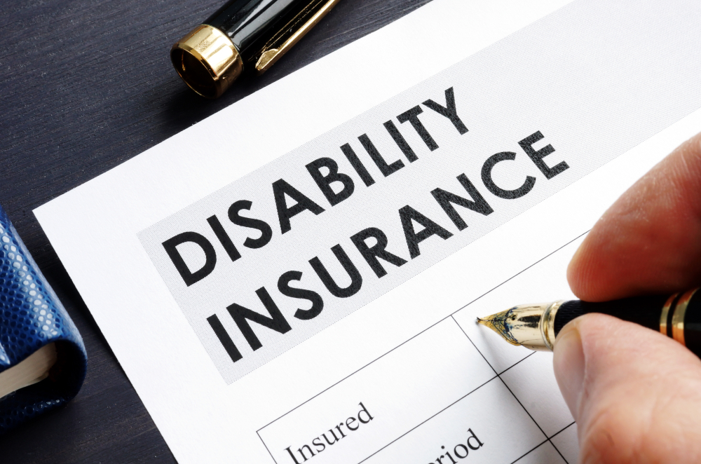 Image of someone signing a disability insurance form