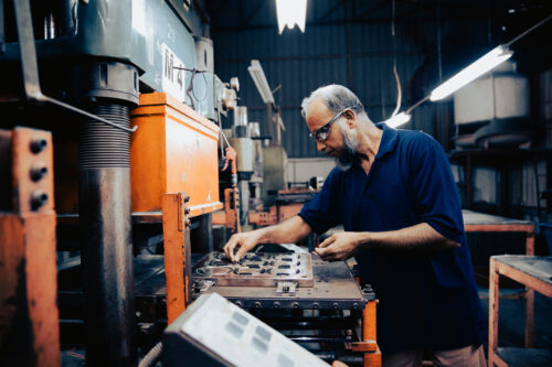 Man performing work on a machine in a factory