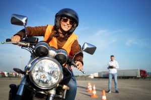 A woman taking the driving test to get her motorcycle license
