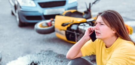a girl talking on the phone after a car motorcycle accident