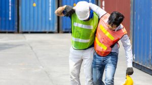 A worker helping another worker after he was injured