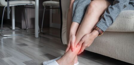 Image of a woman grabbing her ankle in pain