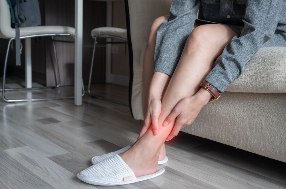 Image of a woman grabbing her ankle in pain