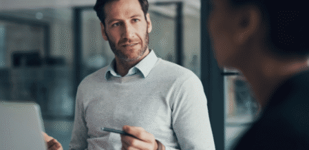 Image of a man dressed in business casual clothes talking to someone