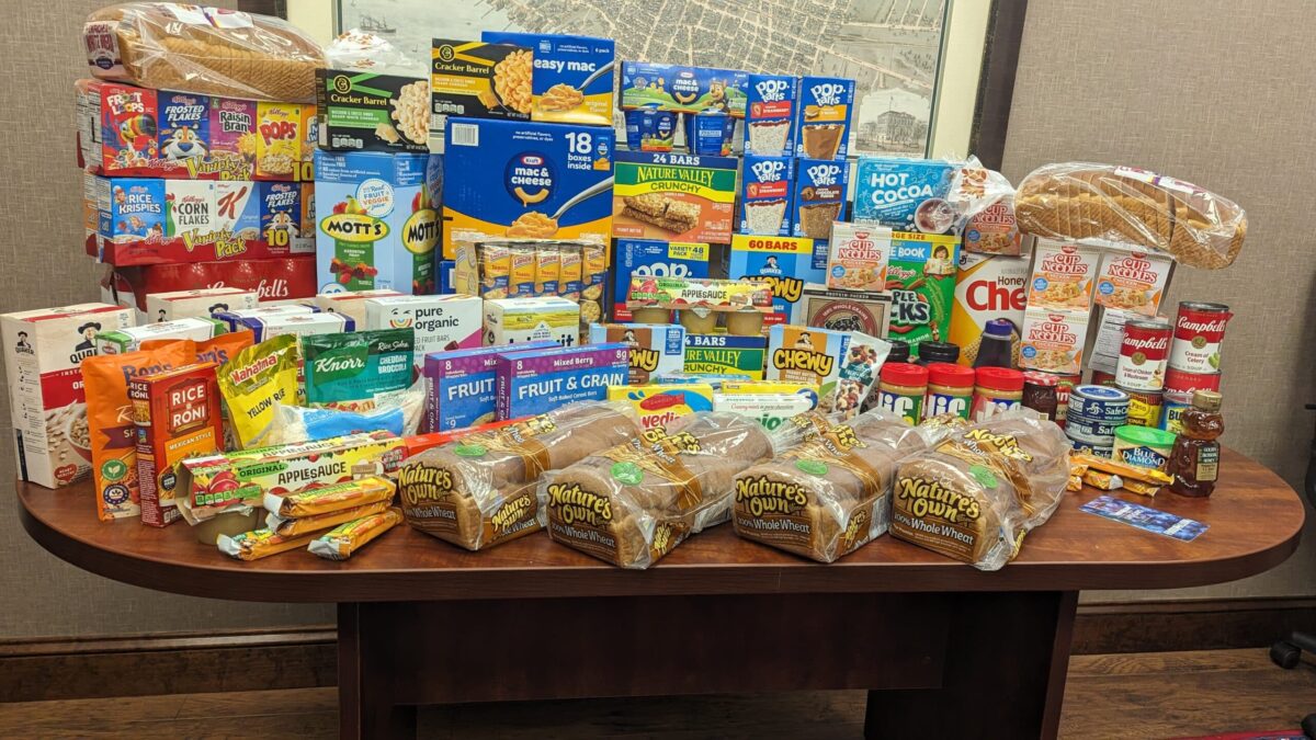table full of food to donate to the Dunston Elementary Food Drive Supporting Communities in Schools Families