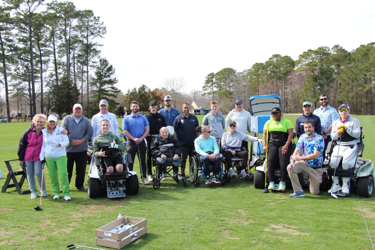 a group of disabled people playing a round of golf