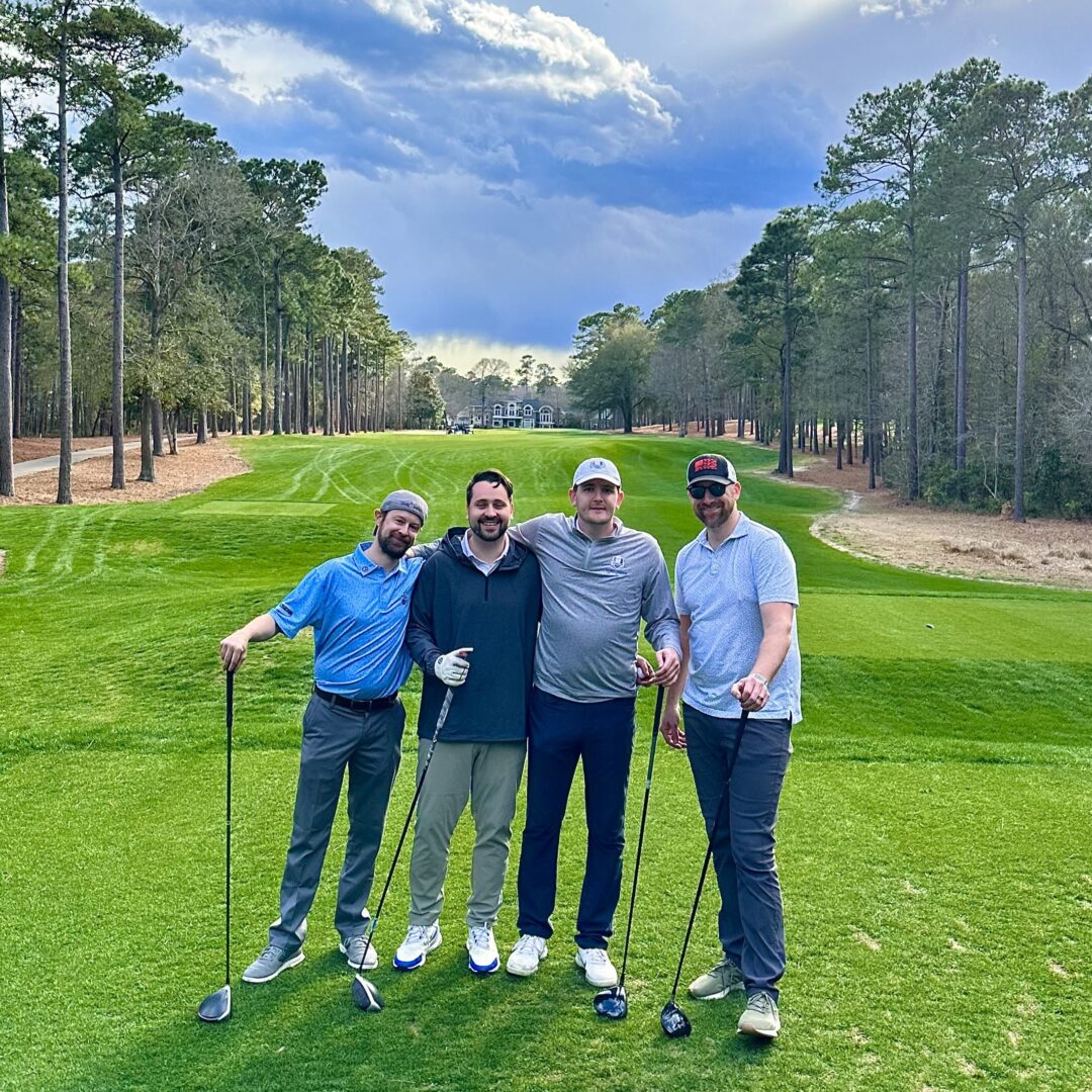 Male employees from Joye Law Firm at a golf course playing a round of golf