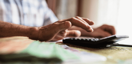 Image of someone typing on a calculator