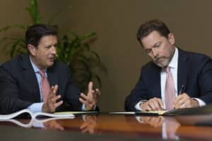 Mark Joye and Ken Harrell sitting at a table discussing a case