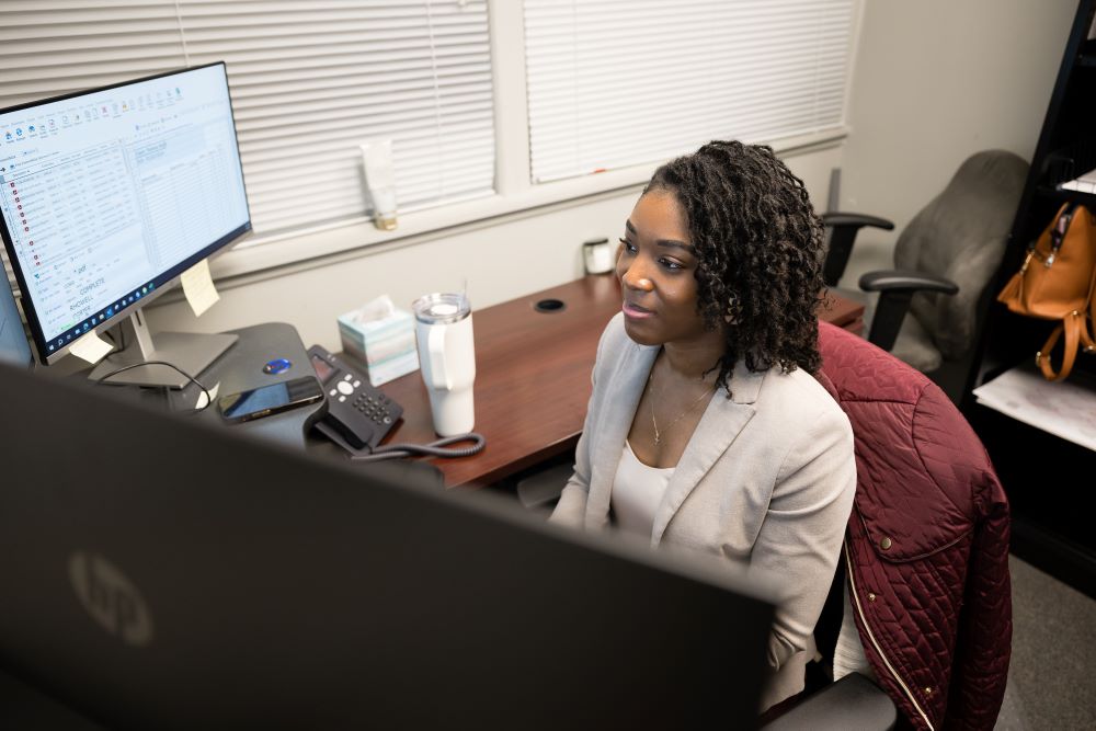 Case Manager working on her computer at Joye Law Firm