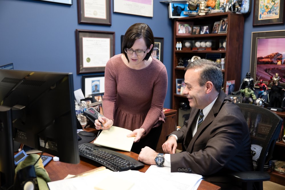 Case Manager Marcy and Attorney Jeff Gerardi discuss a personal injury case at the Summerville office.